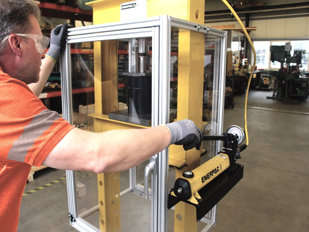 hand operated hydraulic press used in a workshop