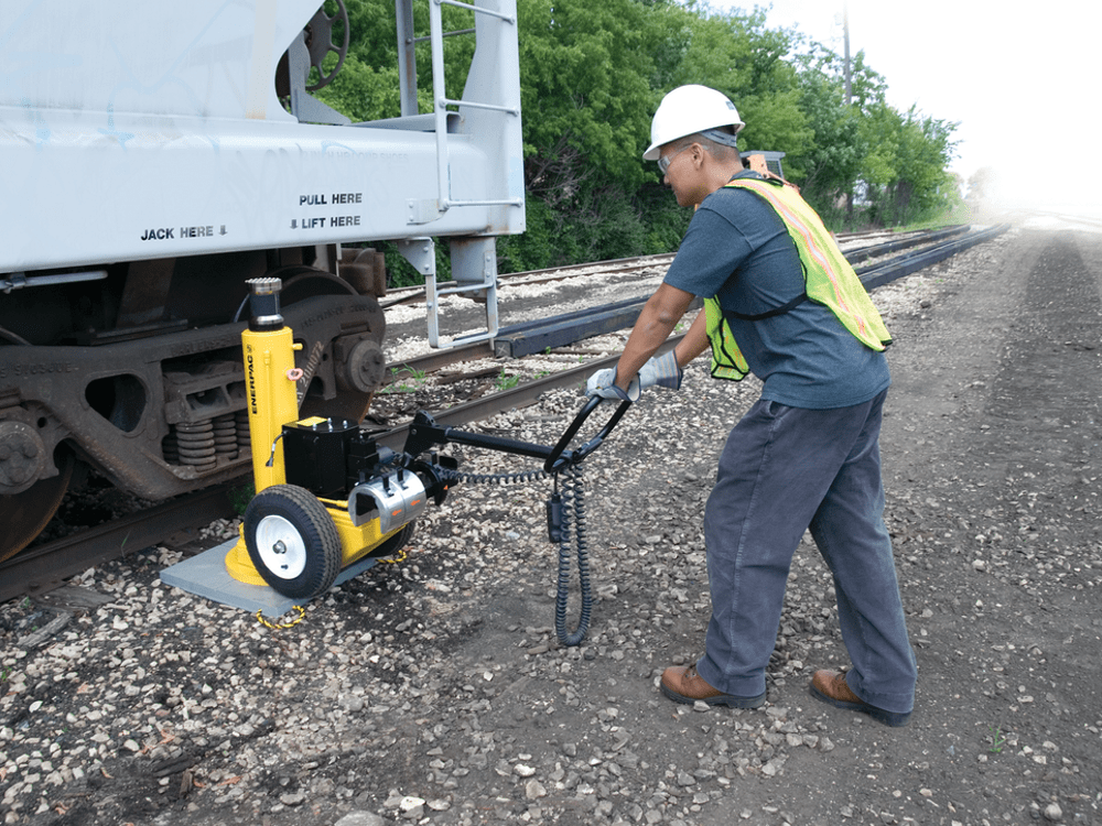 wheeled jack used to lift a railcar on a track