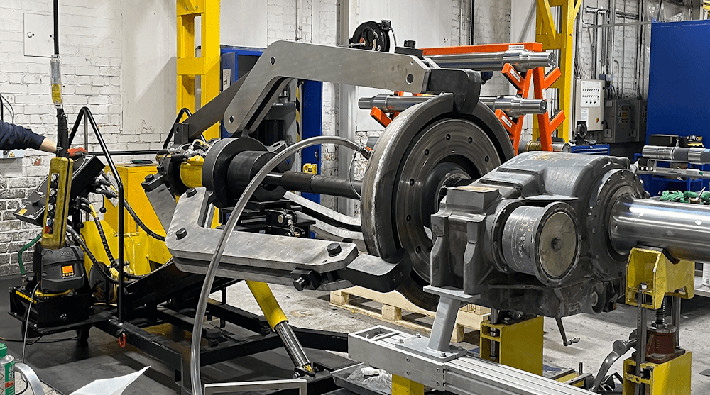 100 ton hydraulic puller removing a train wheel from an axle